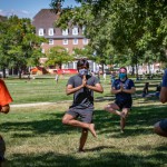 Picture of students practicing yoga on the grass